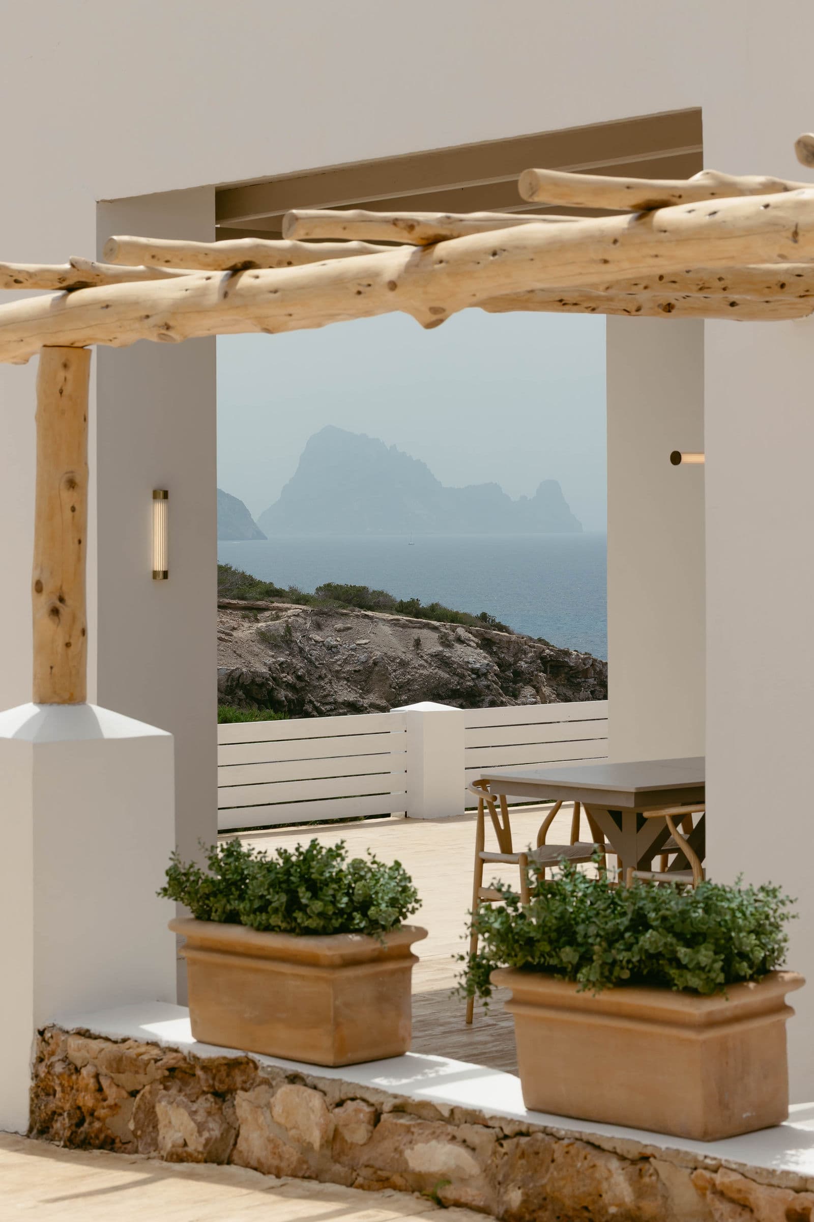 Es Vedrà framed through the wooden pergola at Elixir Ibiza wedding venue